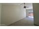Bright living room featuring neutral walls, tile floors, ceiling fan, and sliding glass door at 18629 N 4Th Dr, Phoenix, AZ 85027