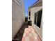 View of the narrow side yard with a red-and-white brick walkway between the buildings at 18629 N 4Th Dr, Phoenix, AZ 85027