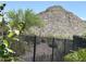 Backyard view with wrought iron fence and mountain views at 18717 N 267Th Dr, Buckeye, AZ 85396