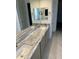 Double sinks and marbled countertops create a spacious and elegant bathroom vanity area at 18717 N 267Th Dr, Buckeye, AZ 85396