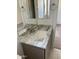 This bathroom has a stylish sink with marble countertop, vanity, and modern fixtures at 18717 N 267Th Dr, Buckeye, AZ 85396