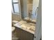 Well lit bathroom vanity featuring a marble countertop, updated hardware, and a view into an attached bath at 18717 N 267Th Dr, Buckeye, AZ 85396