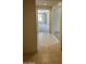 Inviting hallway with tile flooring leading to carpeted rooms with natural light at 18717 N 267Th Dr, Buckeye, AZ 85396