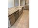 Kitchen island with a farm sink, stainless dishwasher, marble countertop, and light wood cabinets at 18717 N 267Th Dr, Buckeye, AZ 85396