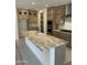 Spacious kitchen featuring stainless steel appliances, ample cabinet space, and a large kitchen island at 18717 N 267Th Dr, Buckeye, AZ 85396