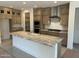 Kitchen showcasing a large center island, stainless steel appliances, and custom cabinetry at 18717 N 267Th Dr, Buckeye, AZ 85396