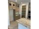 Well-appointed kitchen featuring a pantry, stainless steel appliances, granite countertops and ample cabinet space at 18717 N 267Th Dr, Buckeye, AZ 85396