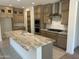 Modern kitchen with island, stainless steel appliances, and granite countertops at 18717 N 267Th Dr, Buckeye, AZ 85396