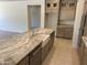 Bright kitchen features a spacious island with a farmhouse sink and stainless steel appliances at 18717 N 267Th Dr, Buckeye, AZ 85396