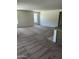 Spacious living room with plush carpeting, large windows, and plenty of natural light at 18717 N 267Th Dr, Buckeye, AZ 85396