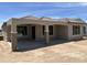 A covered patio with columns provides a shaded outdoor living space at 18717 N 267Th Dr, Buckeye, AZ 85396