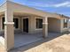 A covered patio with columns creates an inviting outdoor space for relaxation and entertainment at 18717 N 267Th Dr, Buckeye, AZ 85396