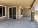 A covered patio features recessed lights, windows, and sliding glass doors to bring the inside out at 18717 N 267Th Dr, Buckeye, AZ 85396