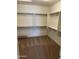 Carpeted walk-in closet featuring built in shelving and metal hanging rods for optimum storage at 18717 N 267Th Dr, Buckeye, AZ 85396