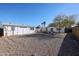 Spacious backyard features gravel, a privacy fence, and mature landscaping at 1950 W Palm Ln, Phoenix, AZ 85009