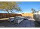 Spacious backyard featuring lounge furniture, mature tree, and a wooden fence for privacy at 1950 W Palm Ln, Phoenix, AZ 85009