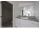 Modern bathroom featuring a large vanity mirror, contemporary sink, and a tiled shower with modern fixtures at 1950 W Palm Ln, Phoenix, AZ 85009