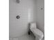 White tiled bathroom featuring a shower and toilet area, with modern fixtures and design at 1950 W Palm Ln, Phoenix, AZ 85009