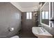 Bathroom featuring gray hexagon tile, vanity sink, lighted mirror, and brushed steel shower head at 1950 W Palm Ln, Phoenix, AZ 85009