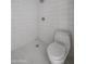 All-white bathroom with a shower and toilet area, featuring a tiled floor and walls in a modern style at 1950 W Palm Ln, Phoenix, AZ 85009