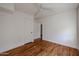 Bright bedroom featuring hardwood floors, white walls, and a doorway leading to other spaces at 1950 W Palm Ln, Phoenix, AZ 85009