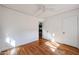 Bright bedroom featuring hardwood floors, white walls, and a doorway leading to other spaces at 1950 W Palm Ln, Phoenix, AZ 85009