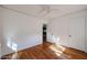 Bright bedroom featuring hardwood floors, white walls, and a doorway leading to other spaces at 1950 W Palm Ln, Phoenix, AZ 85009