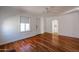 Hardwood floors grace this living room that features a charming archway and bright natural light at 1950 W Palm Ln, Phoenix, AZ 85009