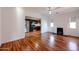 Open-concept living room showcasing beautiful hardwood floors, a fireplace, and seamless access to the kitchen at 1950 W Palm Ln, Phoenix, AZ 85009