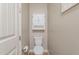 Cozy bathroom with a toilet, a medicine cabinet, and a toilet paper holder at 20641 W College Dr, Buckeye, AZ 85396