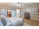 Spacious bedroom with a view of the bathroom through a white sliding barn door at 20641 W College Dr, Buckeye, AZ 85396