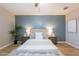 Comfortable bedroom featuring a queen bed with decorative pillows and a neutral color scheme at 20641 W College Dr, Buckeye, AZ 85396