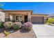 Charming single-story home with desert landscaping, covered porch, and two-car garage at 20641 W College Dr, Buckeye, AZ 85396