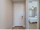 Bright hallway with wood floors leads to a bedroom featuring a ceiling fan at 20641 W College Dr, Buckeye, AZ 85396