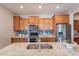 Well-appointed kitchen with stainless steel appliances, sleek countertops, and a modern backsplash at 20641 W College Dr, Buckeye, AZ 85396