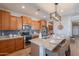 Open-concept kitchen with stainless appliances, a granite island with seating, and stylish lighting at 20641 W College Dr, Buckeye, AZ 85396