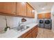 Functional laundry room with ample counter space, storage cabinets, and modern washer/dryer at 20641 W College Dr, Buckeye, AZ 85396