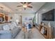 Comfortable living room featuring contemporary decor, a ceiling fan, and ample natural light at 20641 W College Dr, Buckeye, AZ 85396