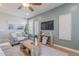 Well-decorated living room with a modern entertainment center and natural light at 20641 W College Dr, Buckeye, AZ 85396