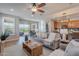 Open-concept living room with seamless access to a modern kitchen and backyard patio at 20641 W College Dr, Buckeye, AZ 85396