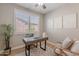 Well-lit office space with a modern desk, comfortable chair, and a large window at 20641 W College Dr, Buckeye, AZ 85396