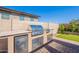 Outdoor kitchen with built-in BBQ, sink, and refrigerator; perfect for backyard grilling and relaxation at 20641 W College Dr, Buckeye, AZ 85396