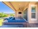 Comfortable covered patio with ample seating, a ceiling fan, and access to the well-maintained yard at 20641 W College Dr, Buckeye, AZ 85396