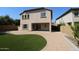 A backyard with a covered patio, a paved area, and artificial grass at 2213 W Marconi Ave, Phoenix, AZ 85023
