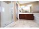 Spacious bathroom featuring a walk-in shower and dual sink vanity at 2213 W Marconi Ave, Phoenix, AZ 85023