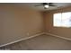 Neutral bedroom with tan walls, carpet flooring, and a ceiling fan at 2213 W Marconi Ave, Phoenix, AZ 85023