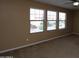 Bedroom with tan walls, neutral carpet, and large windows at 2213 W Marconi Ave, Phoenix, AZ 85023