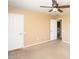 Bedroom with tan walls, neutral carpet and a lighted ceiling fan at 2213 W Marconi Ave, Phoenix, AZ 85023