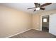 Bedroom with tan walls, neutral carpet and a lighted ceiling fan at 2213 W Marconi Ave, Phoenix, AZ 85023