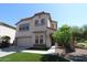 Attractive two-story stucco home with a two-car garage, manicured landscaping, and an inviting entrance at 2213 W Marconi Ave, Phoenix, AZ 85023